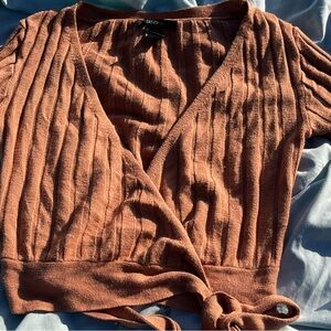 Peach colored wrapped sweater